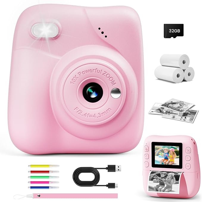 Pink digital instant print camera with paper rolls, memory card, markers and USB cable
